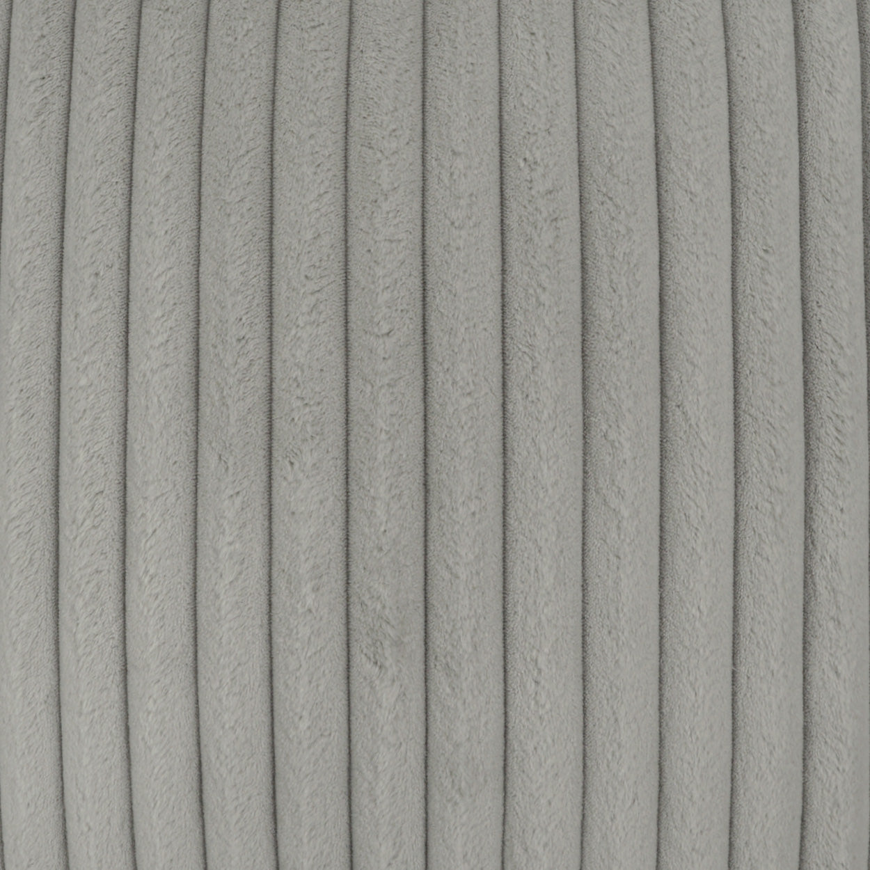 Close-up of light gray corduroy pillow fabric with narrow vertical ribs and soft texture.