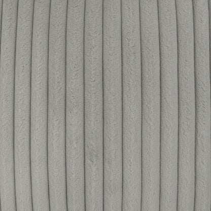 Close-up of light gray corduroy pillow fabric with narrow vertical ribs and soft texture.