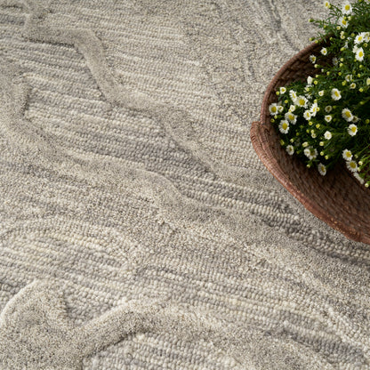 Beige textured rug with a wavy pattern; brown wicker basket of white daisies sits at the top-right.
