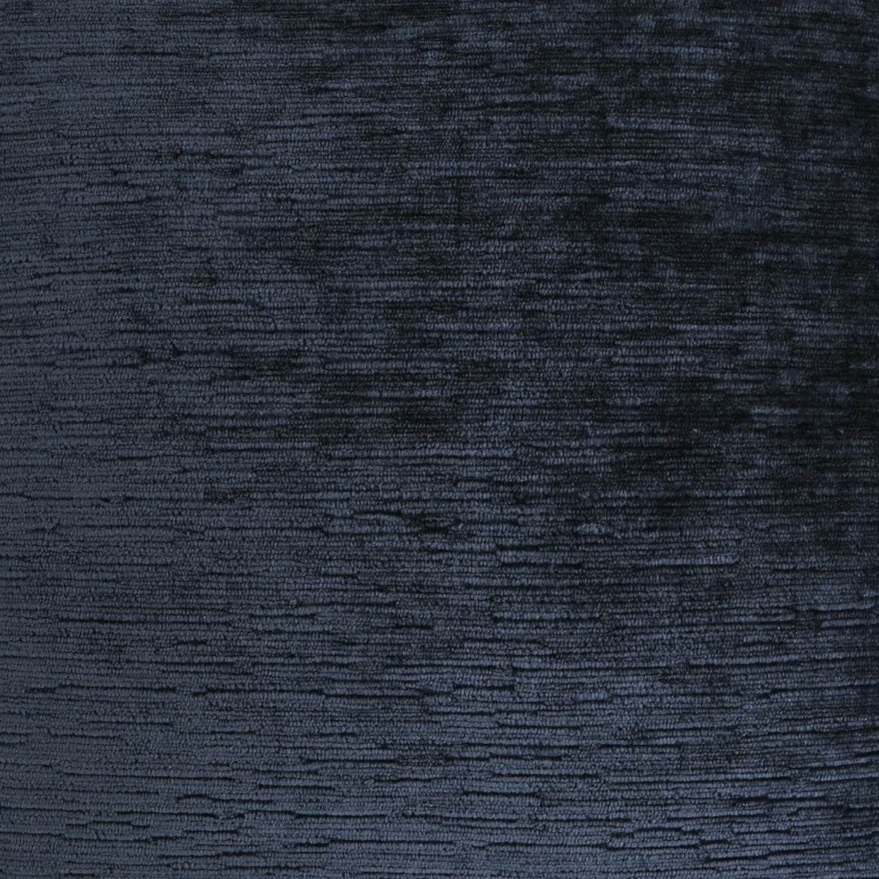 Dark navy velvet fabric close-up with rich sheen and subtle nap texture.