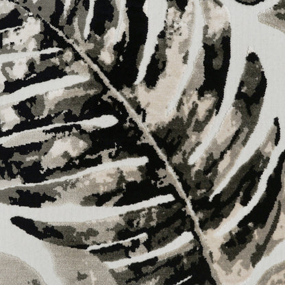 Close-up of beige, black & white palm-leaf patterned fabric on a pillow, abstract botanical print.