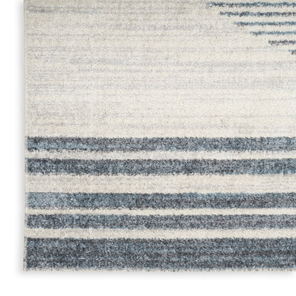 Cream and navy blue striped area rug with soft textured pile and varying-width stripes.