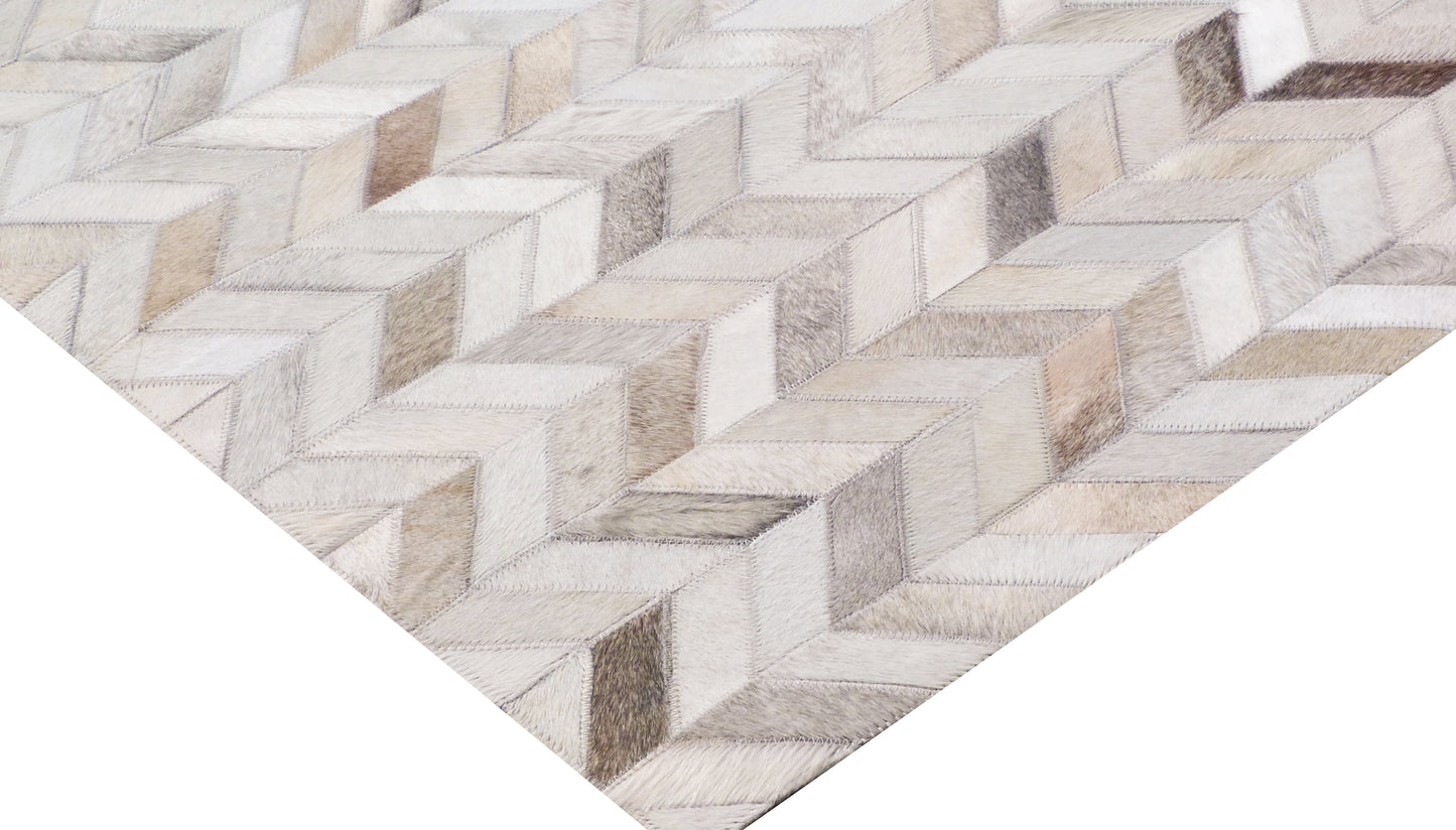 Neutral mosaic leather rug with hand-stitched patchwork in cream, beige & taupe featuring geometric blocks.