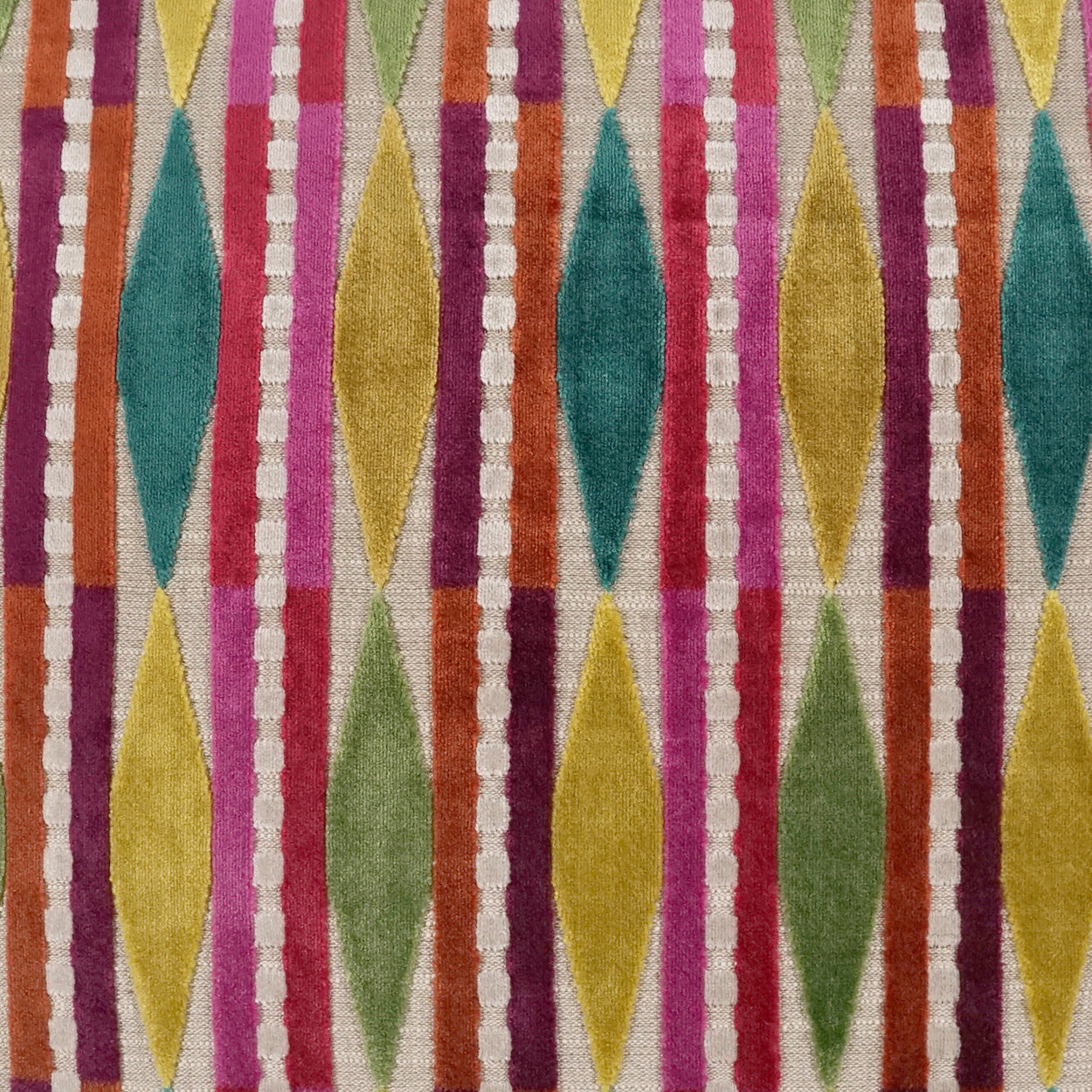 Colorful geometric rug fabric with vertical diamond motifs in teal, yellow, orange, pink, purple and green.
