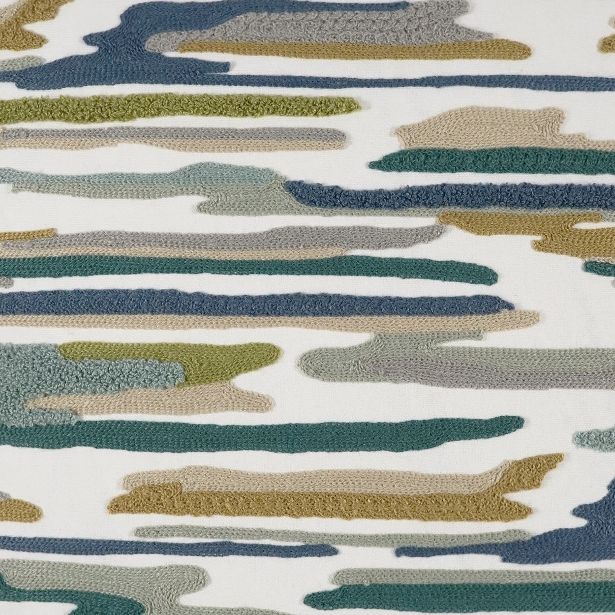 Abstract striped fabric with irregular horizontal brushstrokes in teal, olive, beige, mustard on white; woven textile.