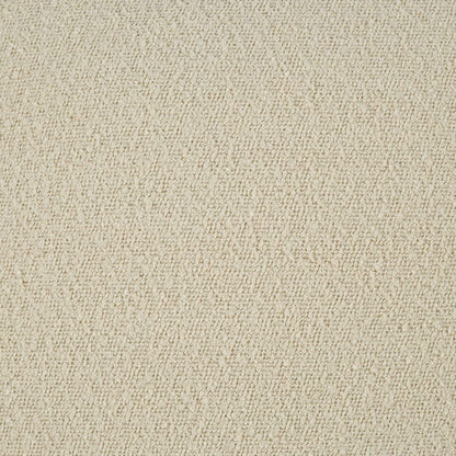 Beige boucle fabric texture with small loop pattern on a pillow; soft upholstery material.