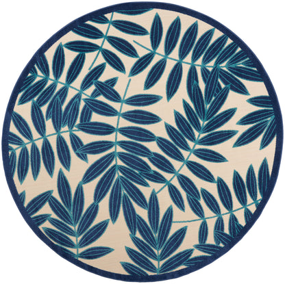 Round rug featuring navy blue fern-like leaves on beige background with a dark blue border.