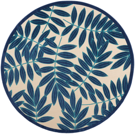Round rug featuring navy blue fern-like leaves on beige background with a dark blue border.
