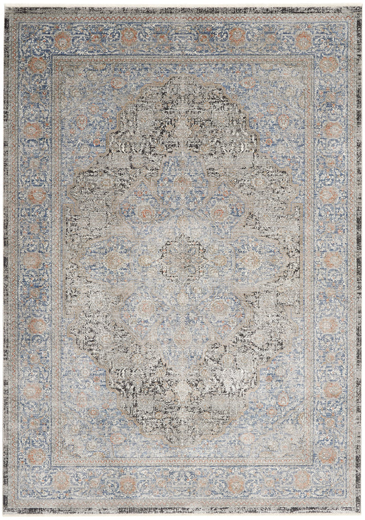 Distressed Persian-style area rug in blue and beige tones with a central medallion and ornate floral border.