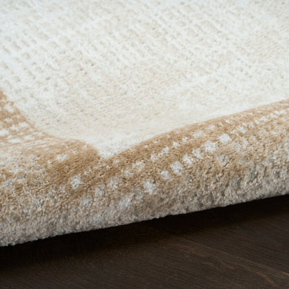 Beige and ivory abstract-pattern rug with plush pile and rolled edge on dark wood floor.