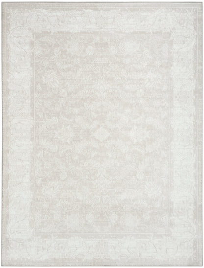 Ivory distressed oriental area rug with subtle floral medallion and faded border.