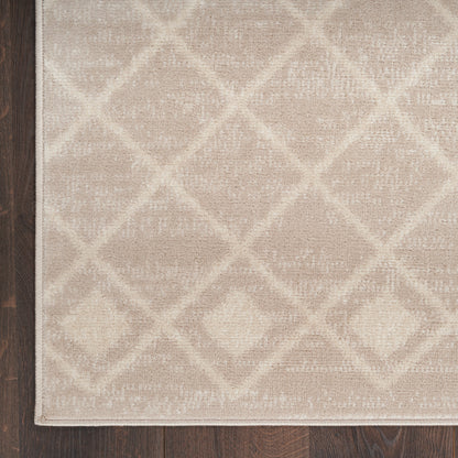 Beige rug with a soft woven texture and a cream diamond lattice pattern, edge-bound, on a dark wood floor.