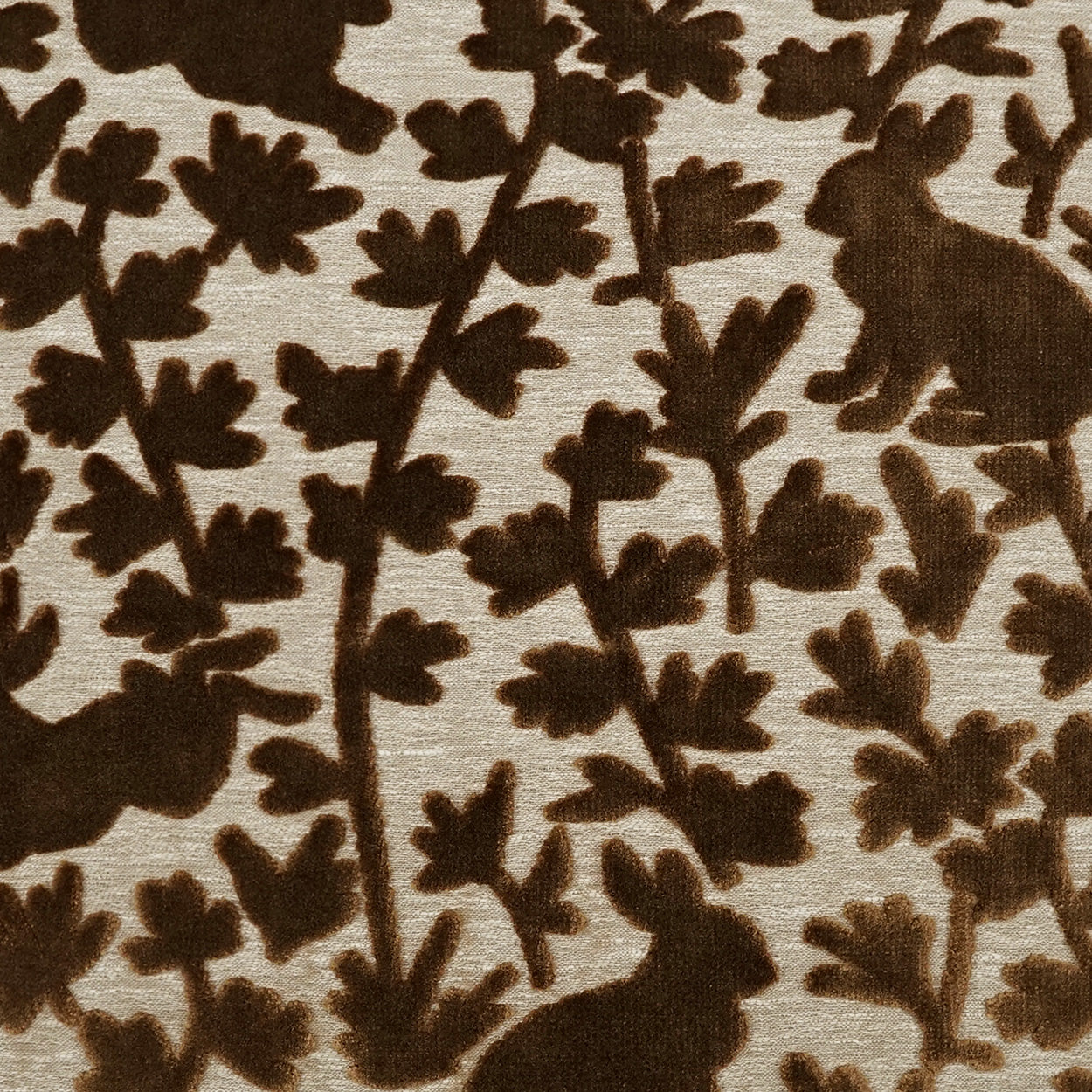 Brown woodland pattern on beige fabric with rabbits and stylized leaves; cozy vintage textile for upholstery or bedding.