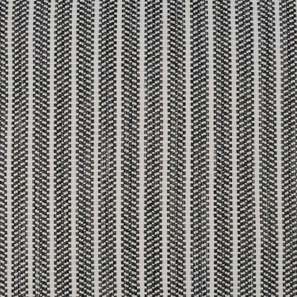 Close-up of grey and black striped woven fabric with a tight chevron pattern.