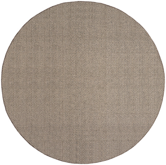 Round natural jute rug with a tight weave in warm beige for outdoor use.