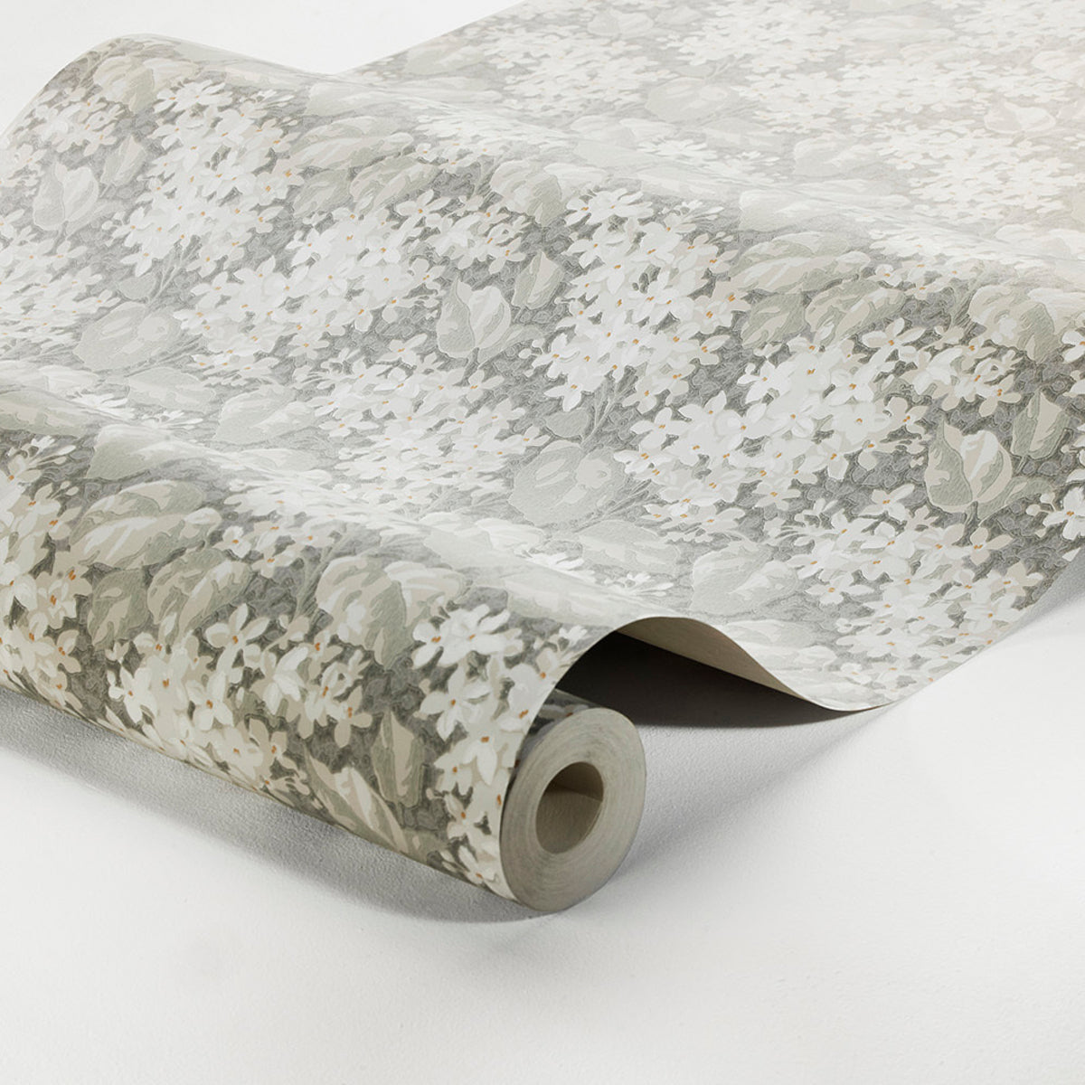 Wallpaper roll with pale gray and white floral print on a light neutral background.