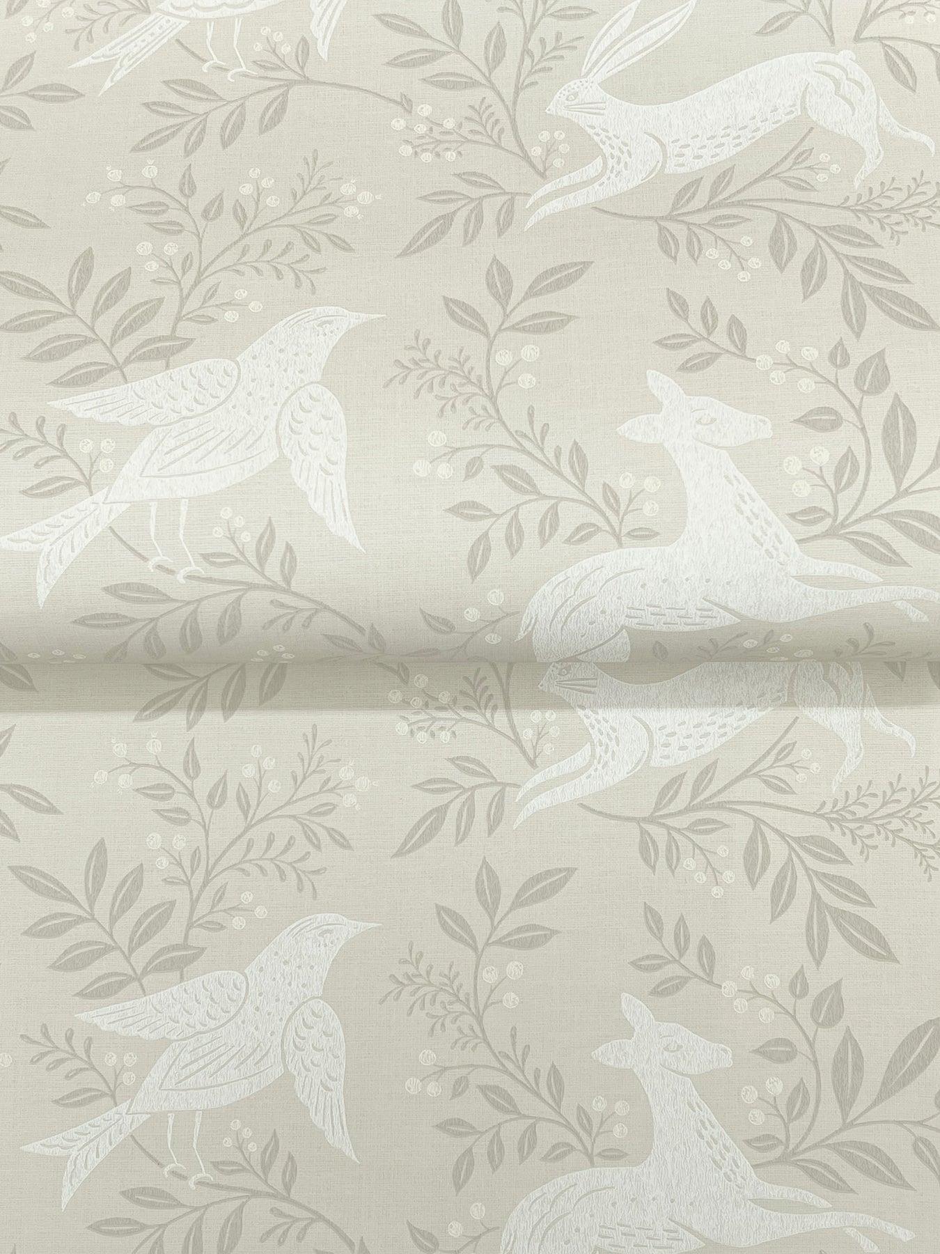 Taupe wallpaper with pale white swallow silhouettes perched among leafy branches.