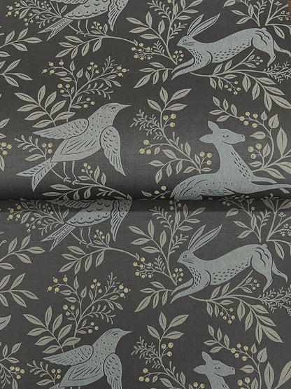 Dark gray fabric with pale blue-gray botanical motif: birds, leaves, berries, and a hare, nature-inspired textile.