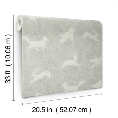 Roll of wallpaper with pale grey-green background and white woodland motif (deer, birds, foliage); 20.5 in wide x 33 ft long