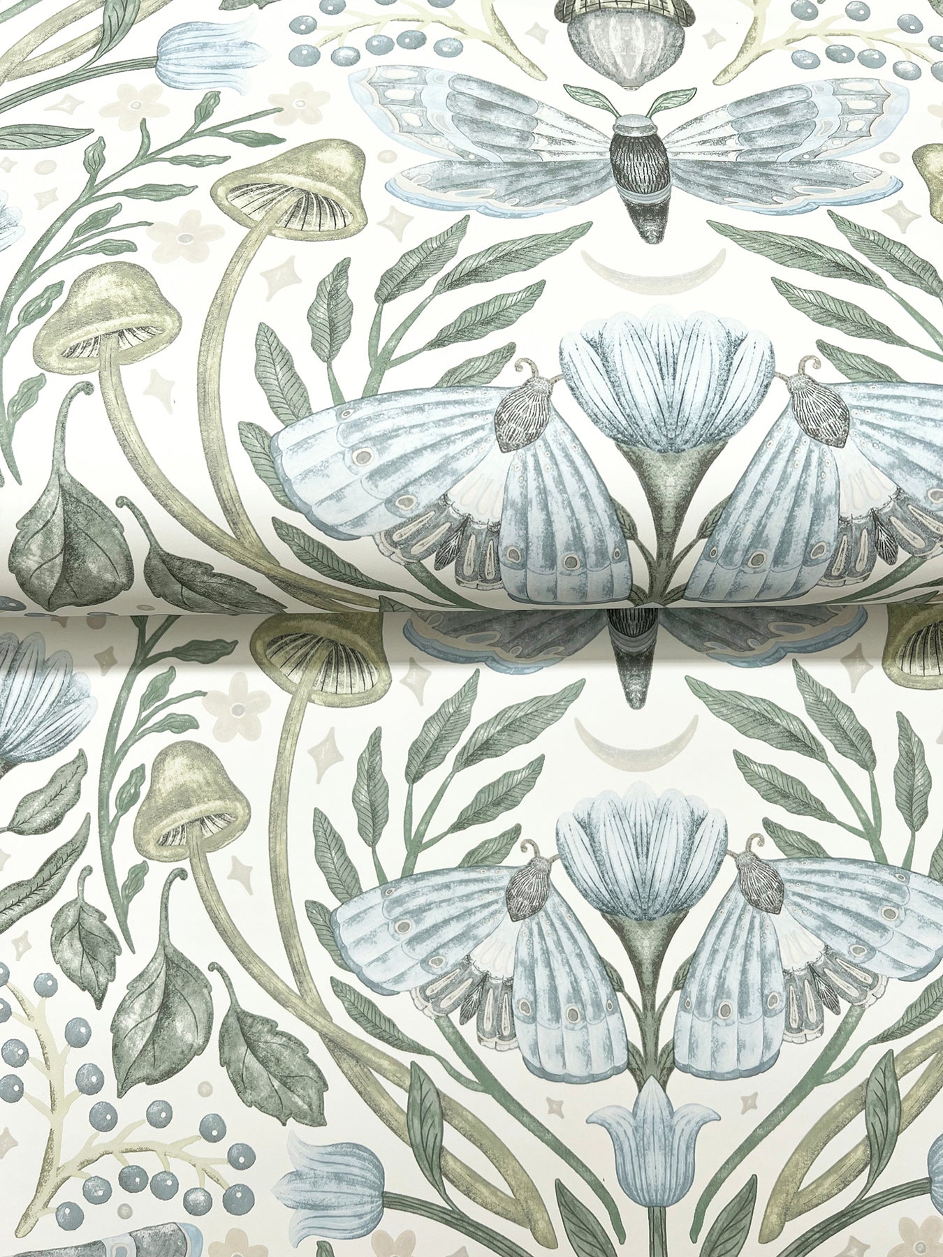 Soft botanical wallpaper motif with pale blue moths, blue flowers and green stems on a sky blue background.
