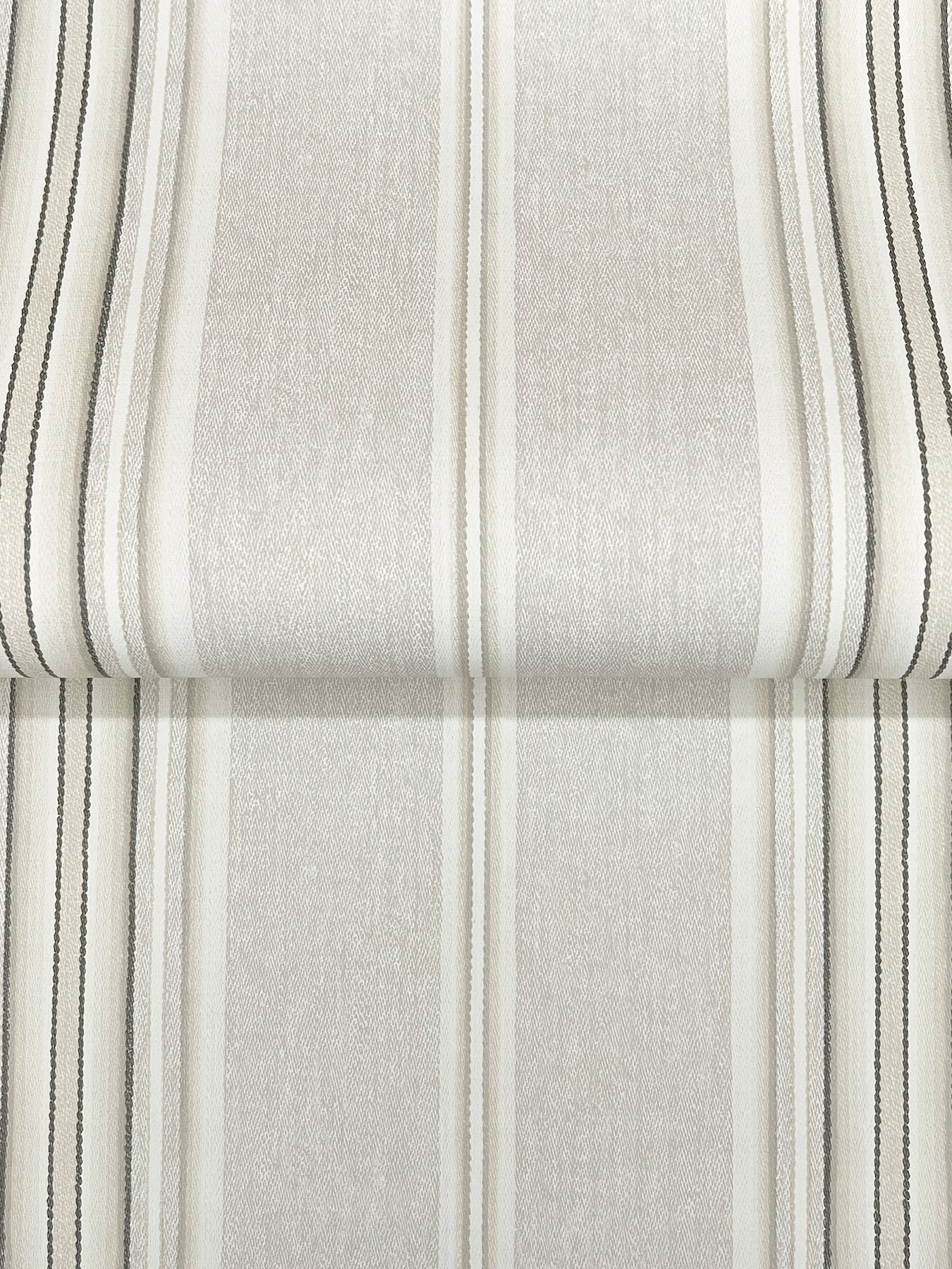 Cream-colored linen-stripe wallpaper with vertical beige, gray, and black stripes; textured surface and folded edge.