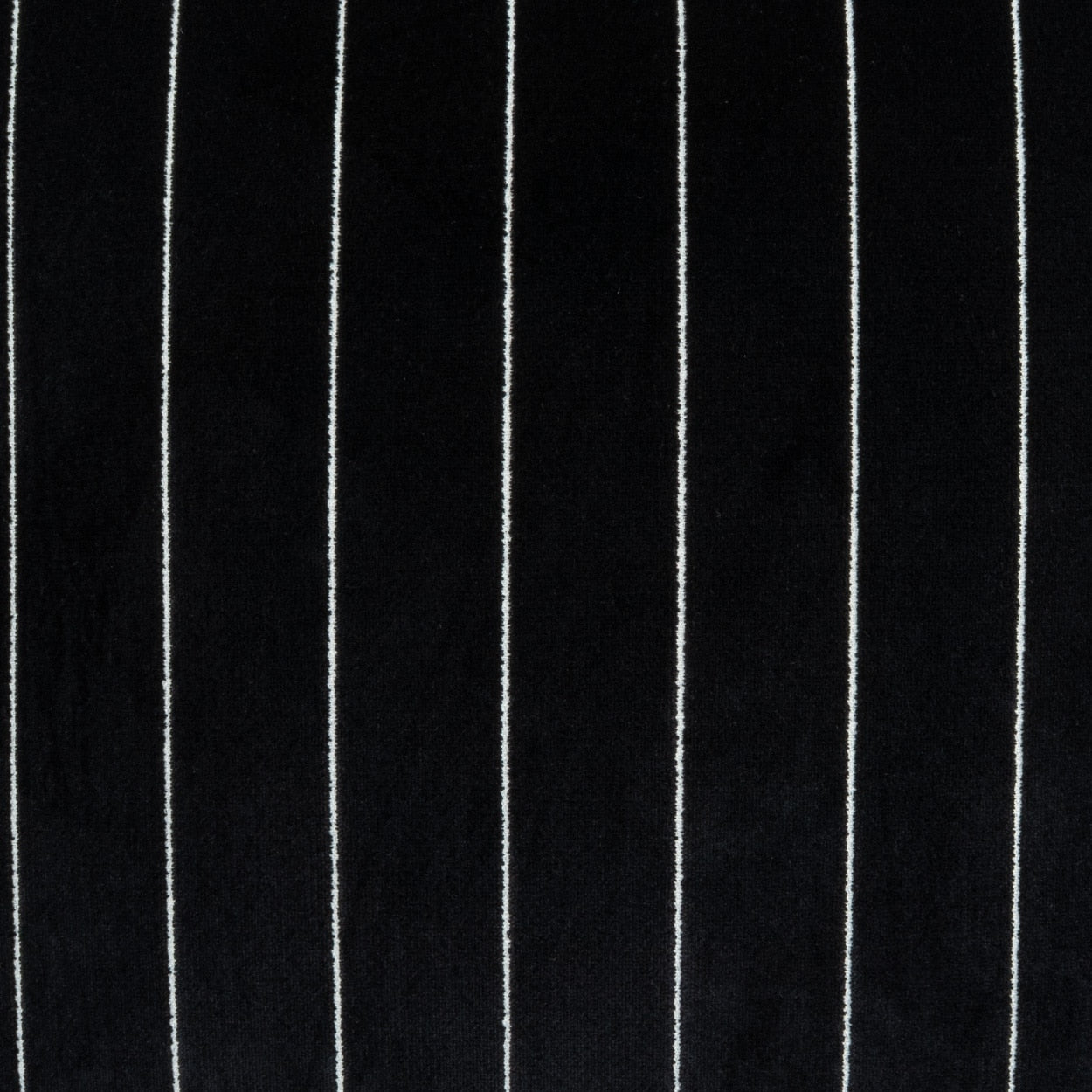 Black fabric with narrow white vertical pinstripes, classic suiting textile.