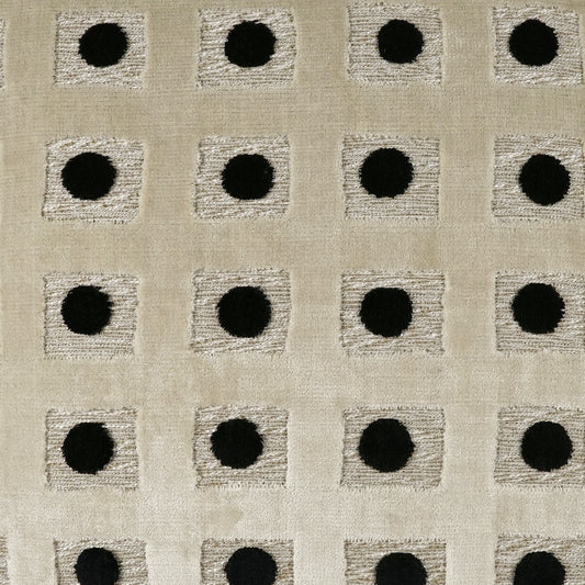 Beige woven fabric with repeating light gray square patches and central black dots; geometric upholstery textile.