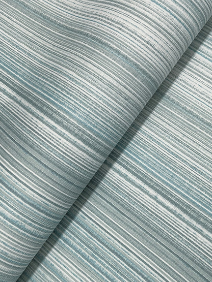 Light blue and white striped wallpaper on a roll with an ombre stripe pattern; modern blue wallpaper.
