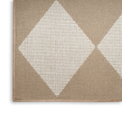 Beige woven rug with large white diamond motifs in a repeating geometric pattern; textured surface.