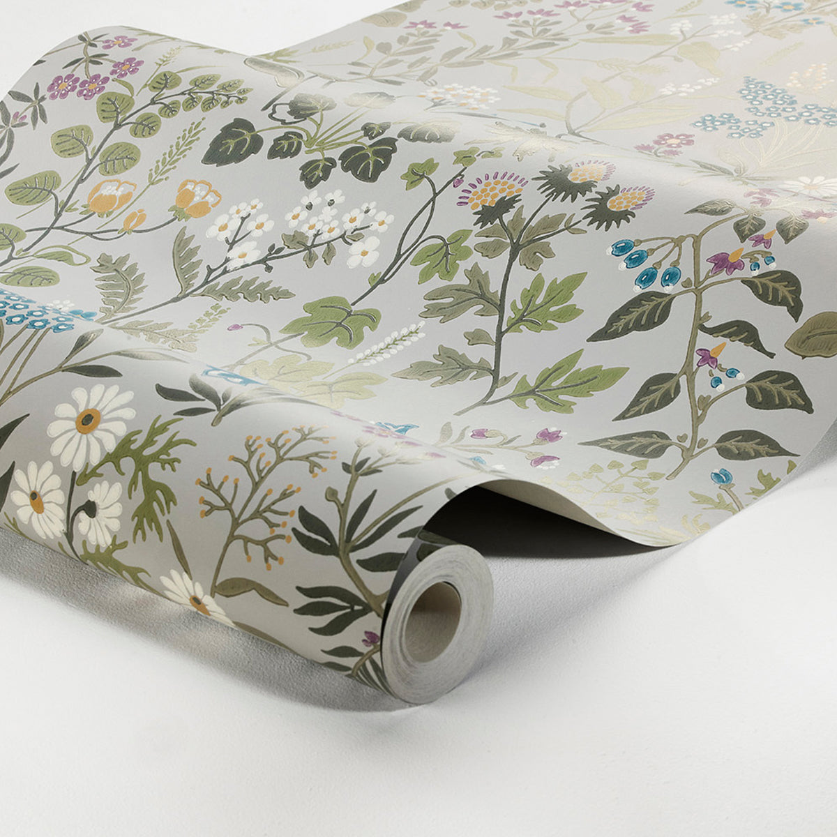 Rolled wallpaper featuring a botanical floral pattern on pale white background; green leaves, daisies, and subtle blooms.