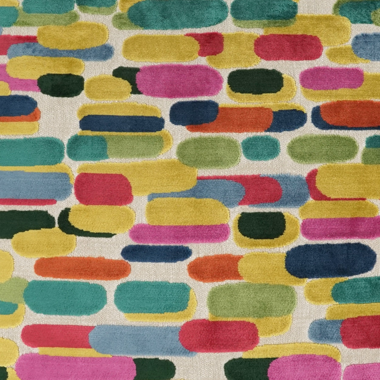 Vibrant abstract fabric print with rounded pill shapes in teal, pink, yellow, blue and green on a light background.