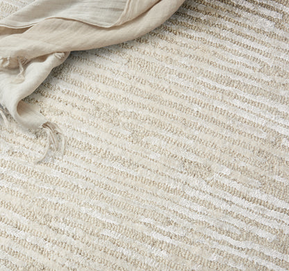 Cream and beige striped woven rug; natural, cozy home decor.