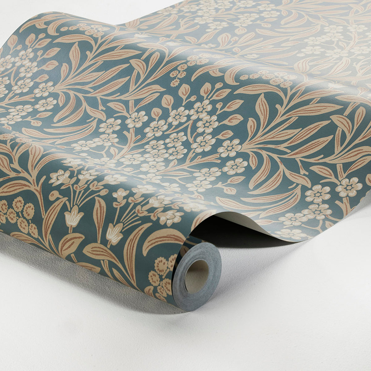 Rolled blue wallpaper with cream floral botanical pattern; vintage-style decorative wall covering.