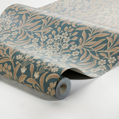 Rolled blue wallpaper with cream floral botanical pattern; vintage-style decorative wall covering.