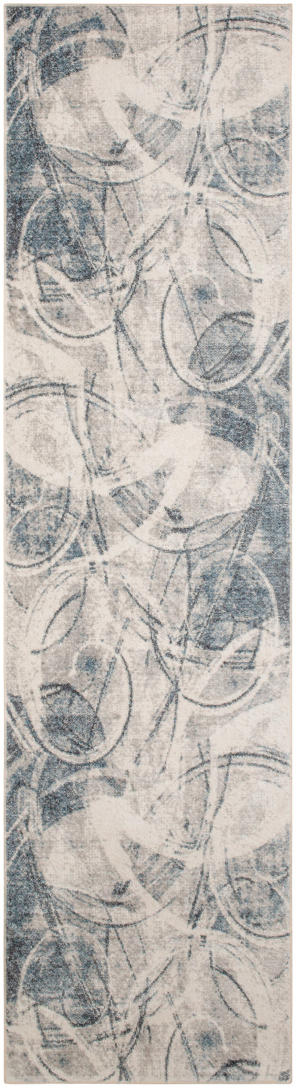 Abstract circular ring pattern in blue-gray tones with overlapping rings and a soft, fabric-like texture.