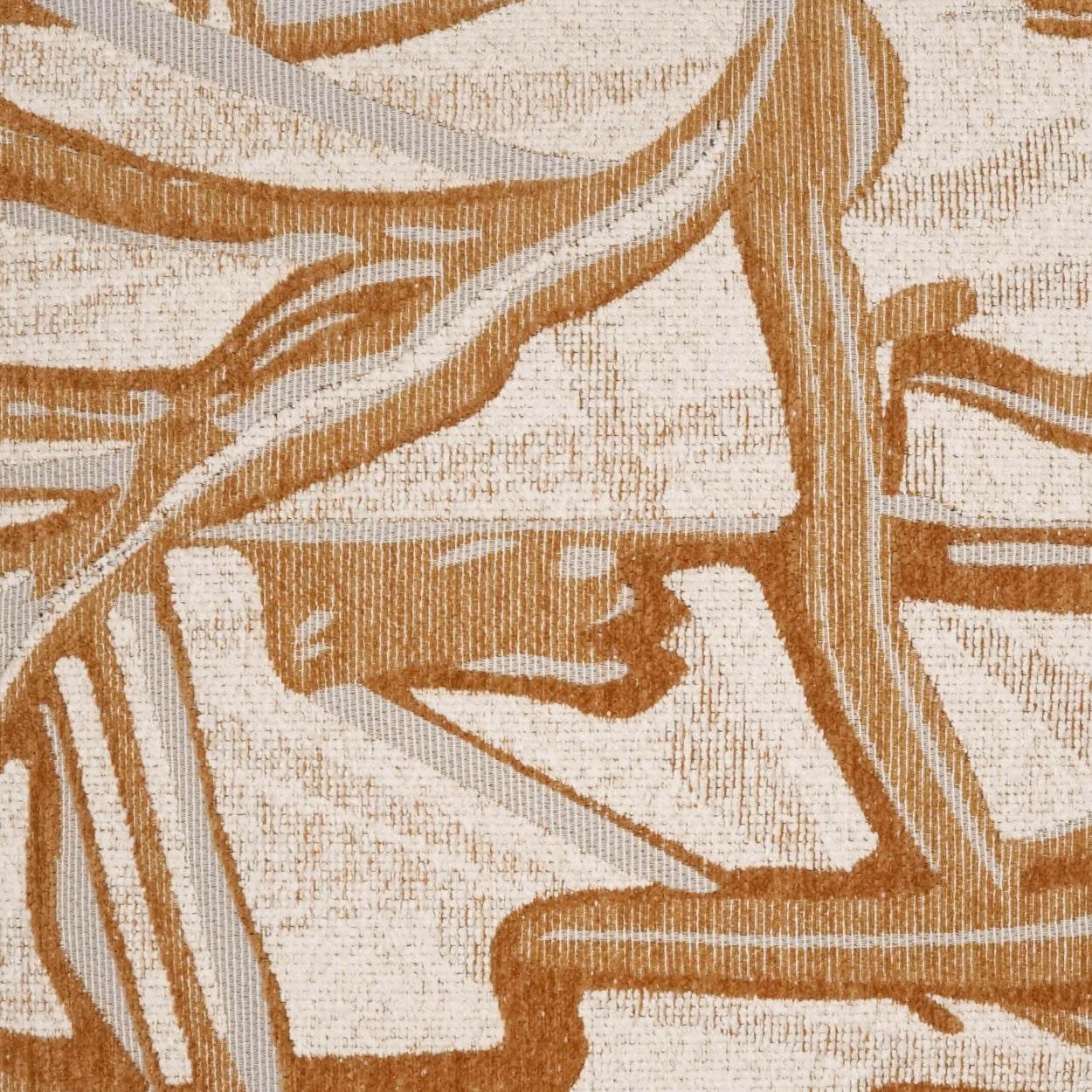 Beige pillow with an abstract floral tan-and-brown brushstroke pattern; textured woven fabric.