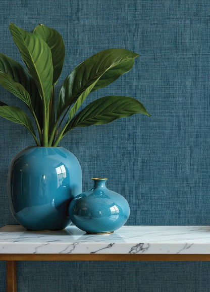 Dark blue open-weave wallpaper with a subtle textured pattern on the wall.