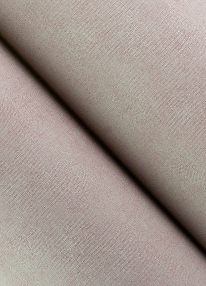 Lavender faux-linen wallpaper close-up showing a diagonal fold and soft matte texture