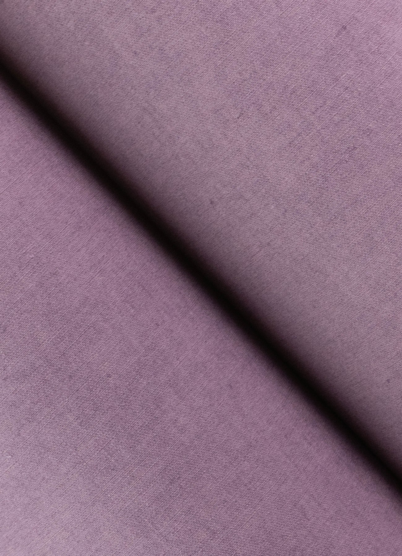 Close-up of purple faux linen wallpaper texture with a diagonal crease.