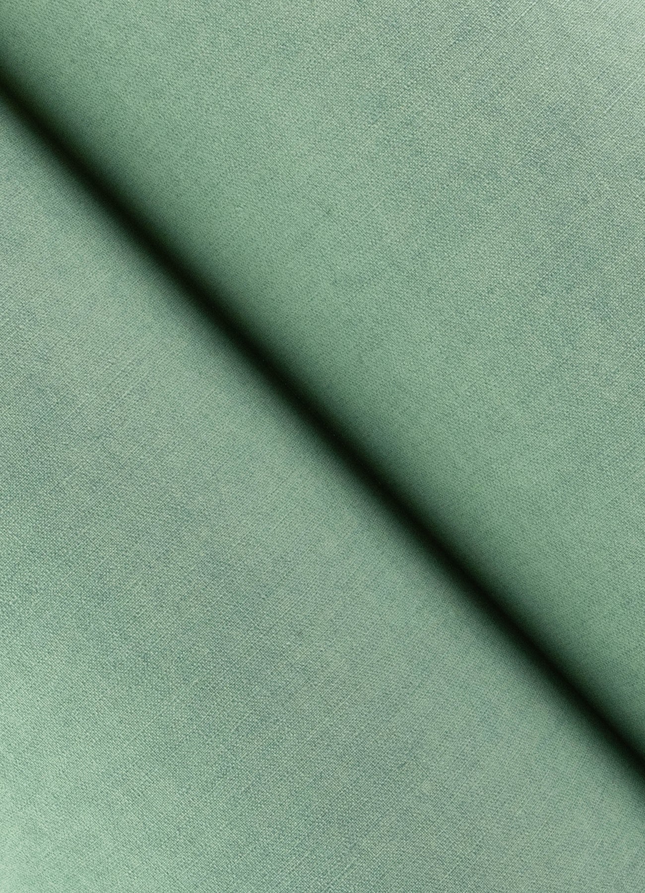 Close-up of aqua faux-linen wallpaper texture with a diagonal seam shadow.