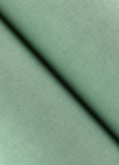 Close-up of aqua faux-linen wallpaper texture with a diagonal seam shadow.
