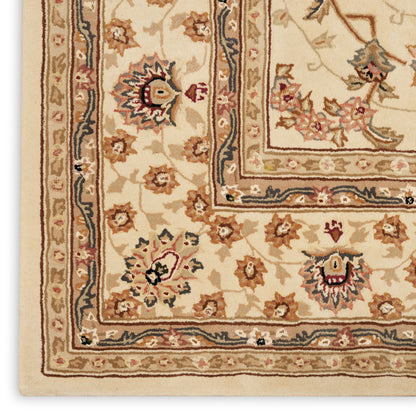 Traditional beige Persian-style rug corner with floral motifs, cream borders and navy blue trim.