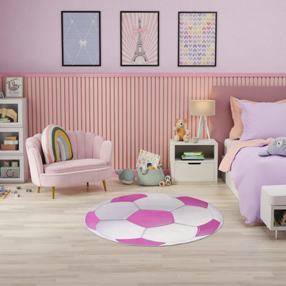 Pastel pink kids' room with round pink-white rug, pink armchair, lavender bedding, striped wall paneling.