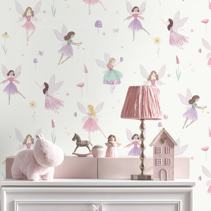 Pastel kids' room scene: white dresser with pink plush bunny, pink lampshade, toy horse, pink decorative house, and fairy wallpaper.