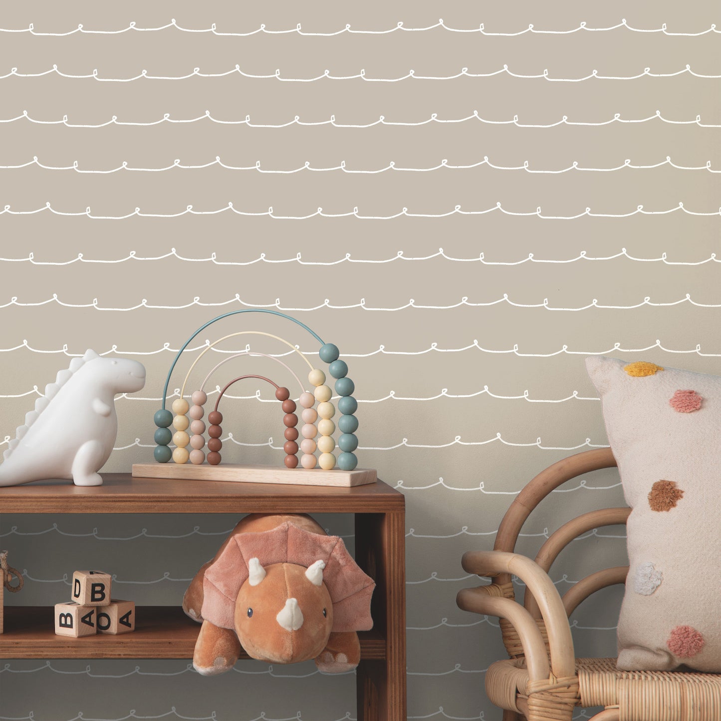 Pastel nursery scene with wooden shelf, beaded arch toy, plush orange lion, white unicorn, rattan chair, polka-dot pillow.