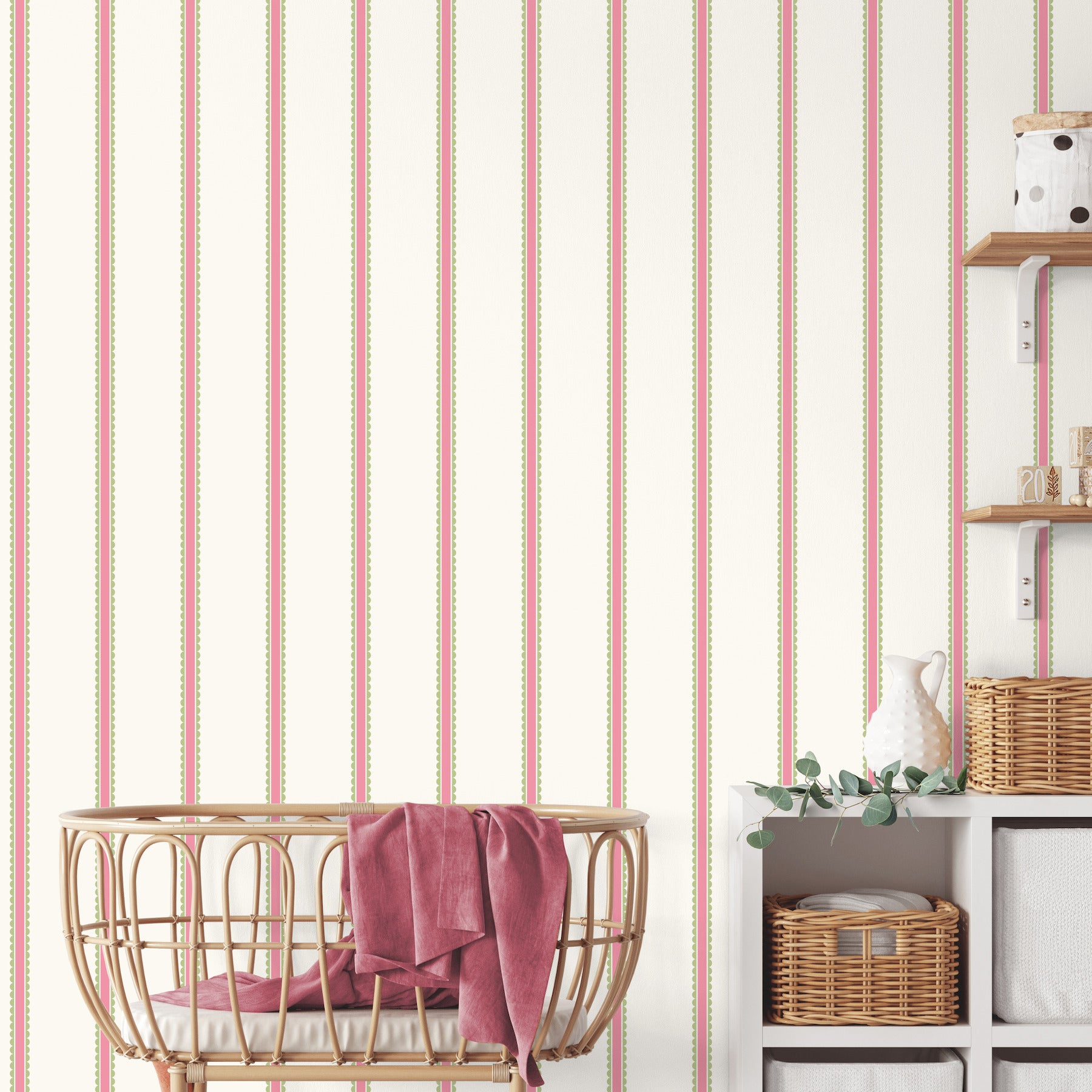 Nursery scene with cream striped wallpaper, a round wicker baby cradle with pink blanket, and shelves with wicker baskets.