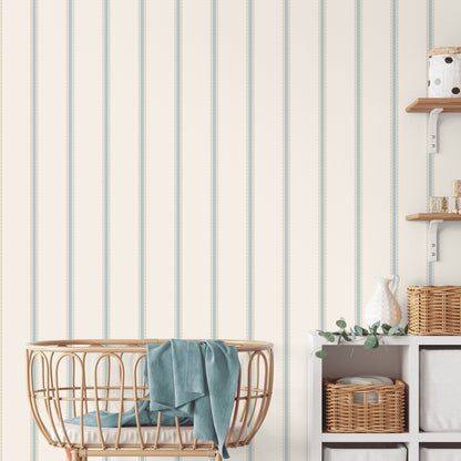 Light blue scalloped bobbin stripe wallpaper with whimsical graphics on a wall.
