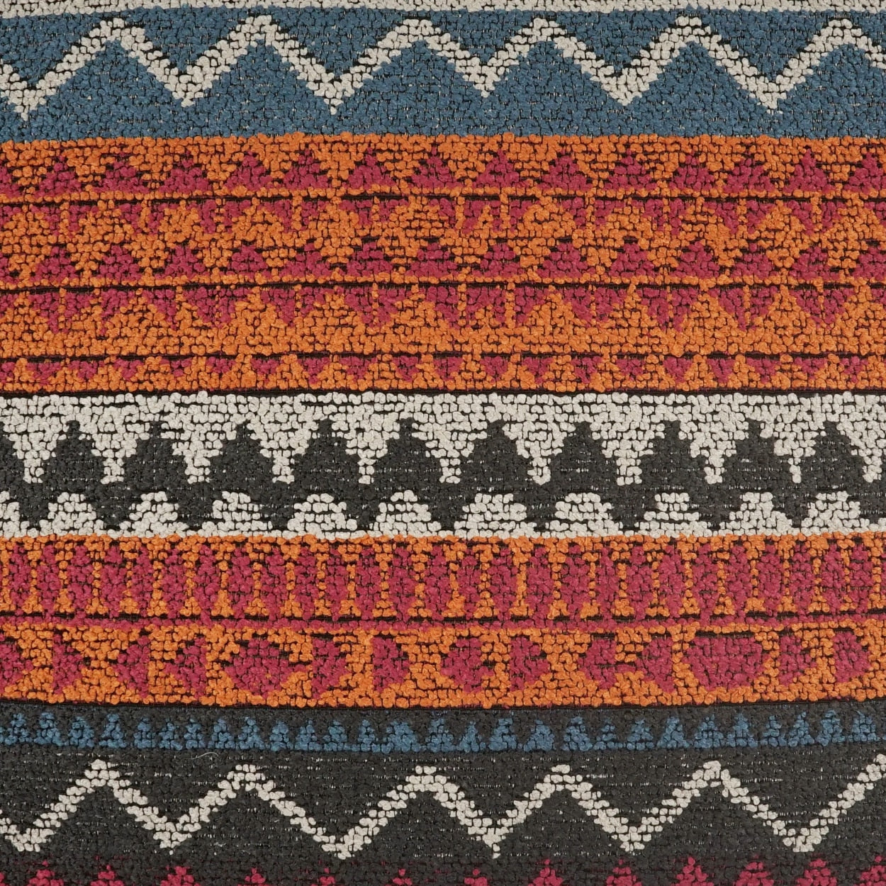 Woven fabric with blue and white zigzag borders and alternating orange, magenta and black geometric stripes.