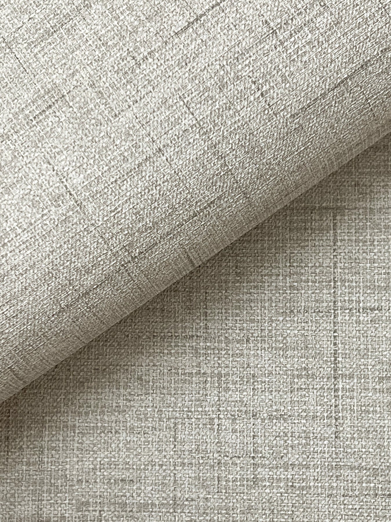 Light grey faux fabric wallpaper with a linen-like crosshatch texture.