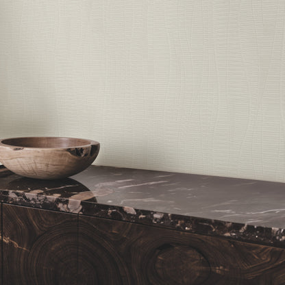 Room featuring grey embossed wallpaper with a subtle graphic pattern.